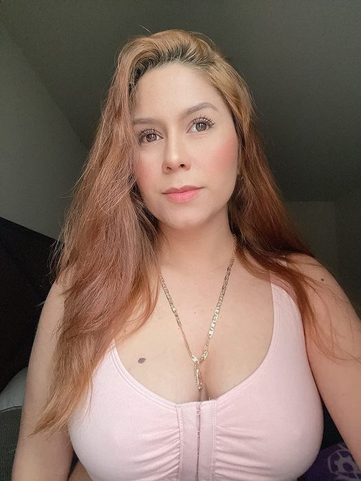 A reviewer modeling the pink bra.