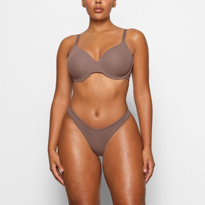 a model showcasing the bra in a brown shade