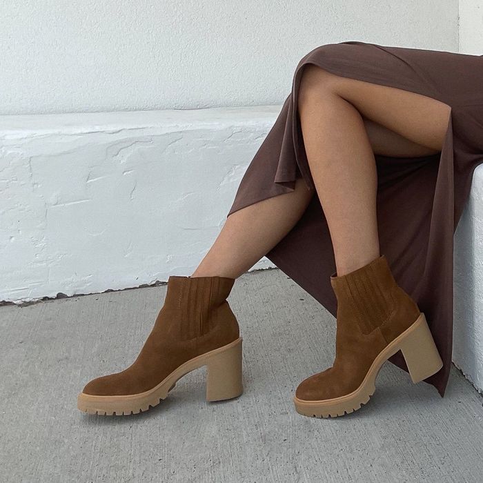 A model showcases the boots in a rich brown version, offering a different but equally fashionable alternative.