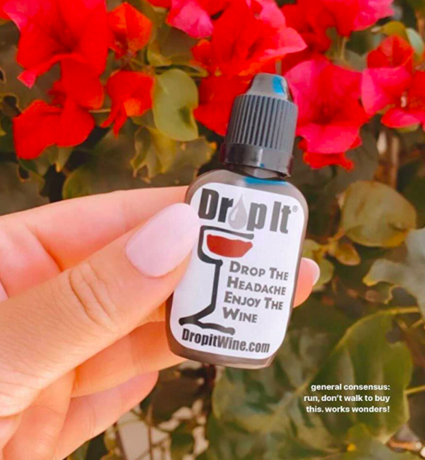 A customer review image showing someone holding the bottle of Drop It Wine Drops