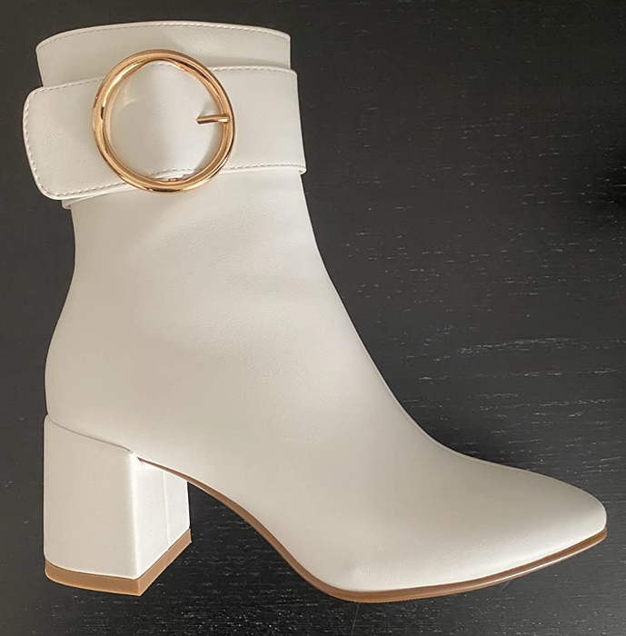 A close-up shot of the reviewer showcasing the white boot.