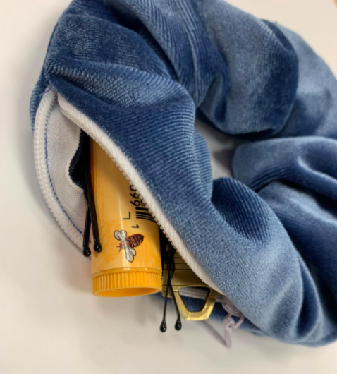 A customer review photo of the scrunchie packed with chapstick, bobby pins, and keys—demonstrating its handy storage features