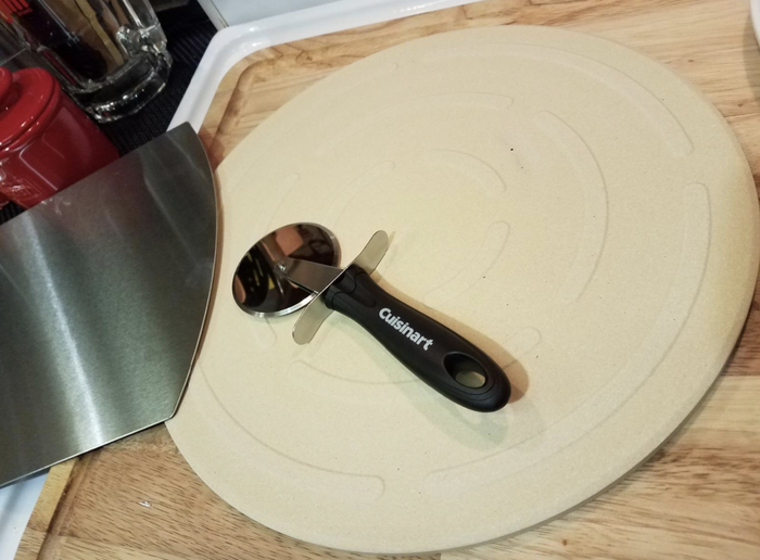A customer photo of them placing a pizza into their oven