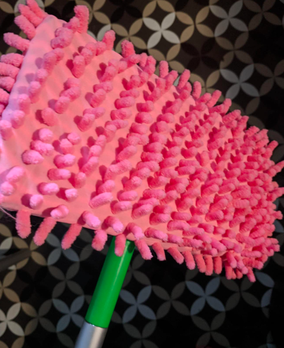A customer review image of the slippers placed on their Swiffer mop