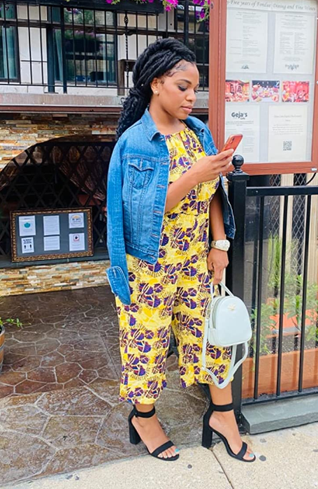 Reviewer sporting black pumps paired with a yellow jumpsuit