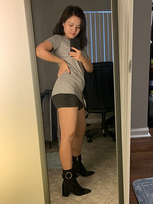 The reviewer styling the black boots.