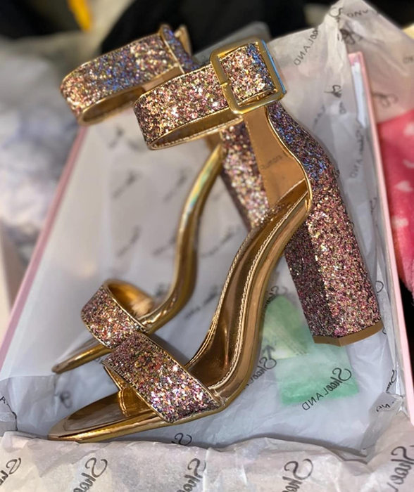 Reviewer photo of the glittery pumps with buckle strap still in their shoebox
