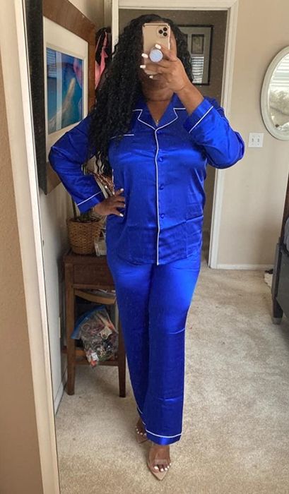 A reviewer is wearing a relaxing blue pajama set.