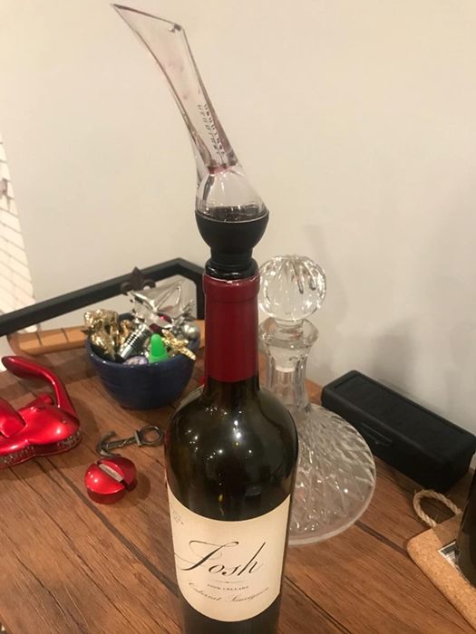 A bottle with the aerator placed on top, ready to release the full potential of the wine's flavor profile.
