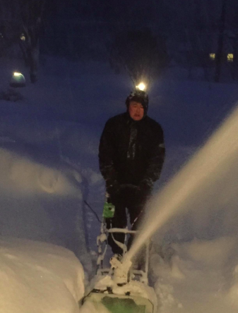 A picture of the snow thrower in action as it clears the snow.