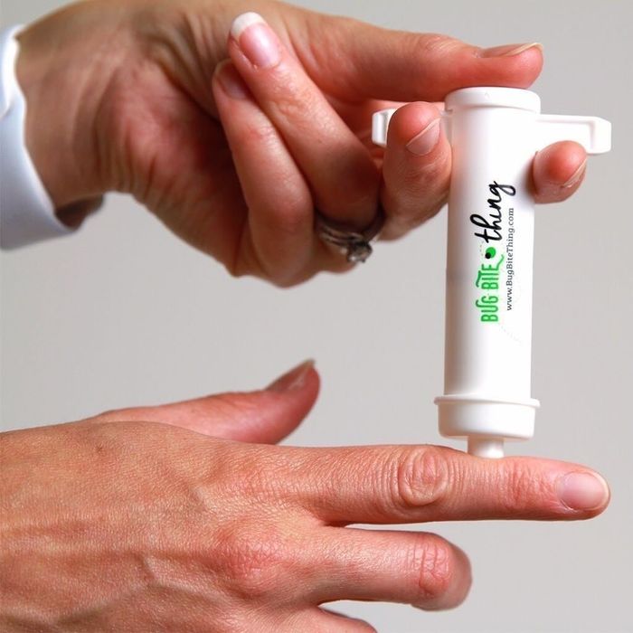 The suction tool placed against a model's finger for use