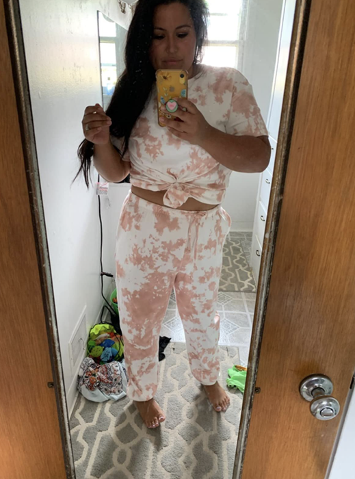 The reviewer is wearing a tie-dye lounge set.
