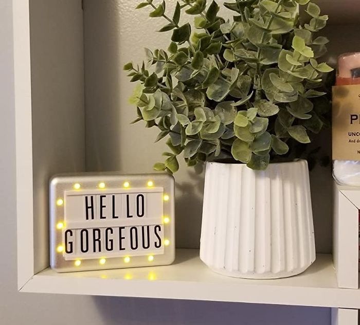 A light-up sign that says 'Hello Gorgeous' with a glowing border.