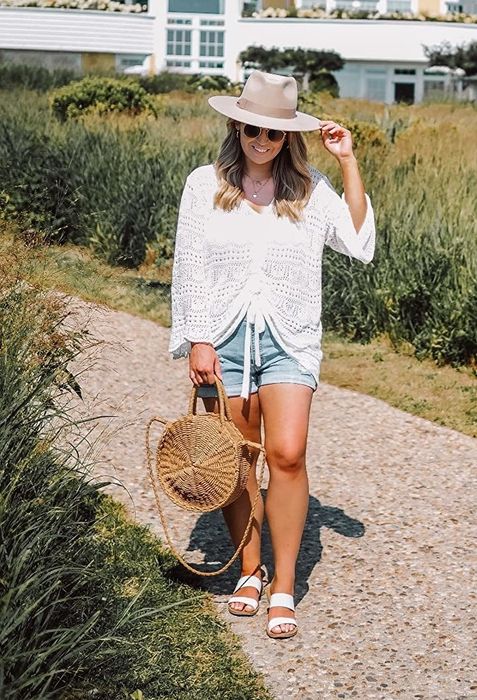 Reviewer wearing shorts, sandals, and a white top