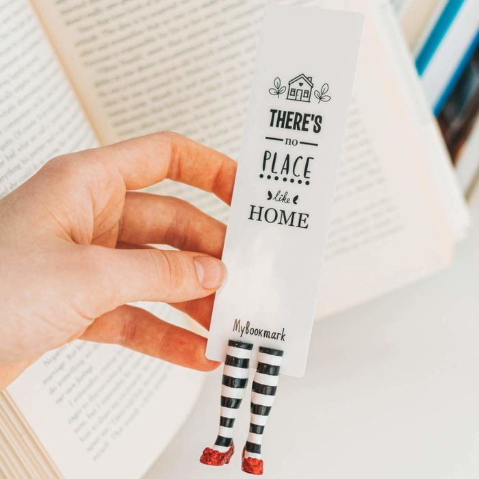 A model displaying the wicked witch bookmark, which features the phrase '