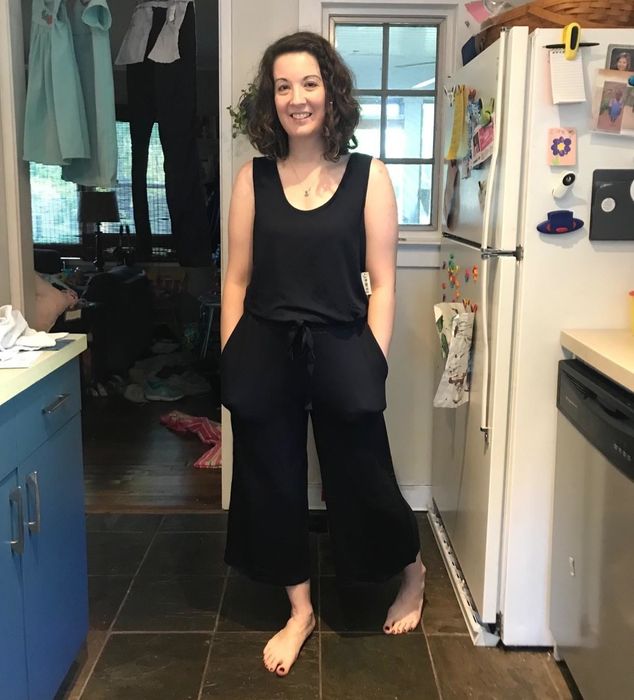 The reviewer is wearing a black jumpsuit.