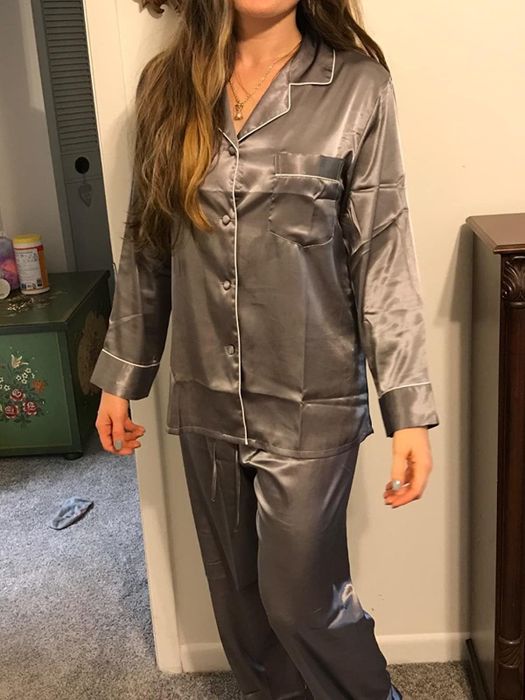 A reviewer is dressed in a cozy gray pajama set.