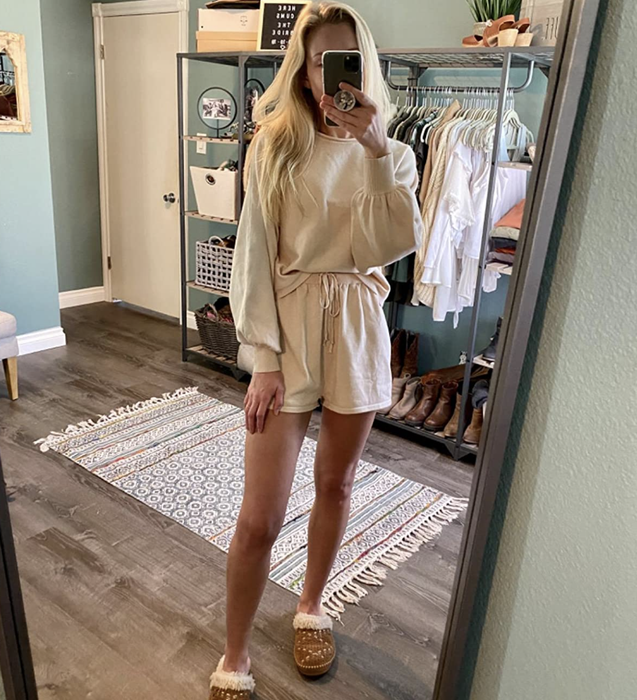 A reviewer is wearing a beige set.