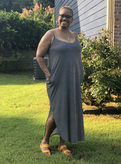 A reviewer is sporting a black and white striped dress.
