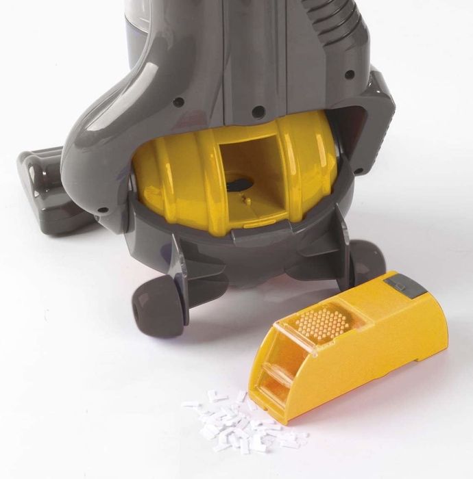 The various parts of the Dyson vacuum are displayed, showcasing its miniature design that brings big cleaning power to kids.