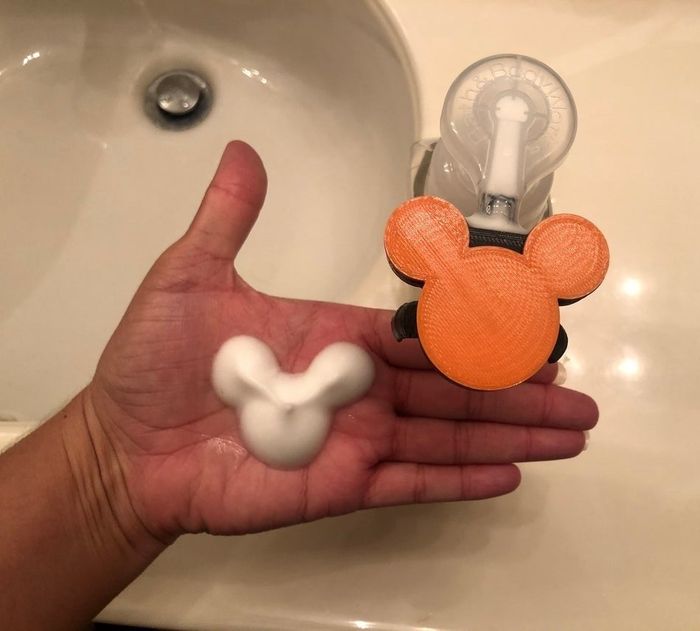 Mickey Mouse-shaped pump attachment that creates soap foam in the shape of Mickey's ears