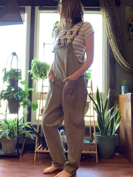 A reviewer is wearing taupe overalls.