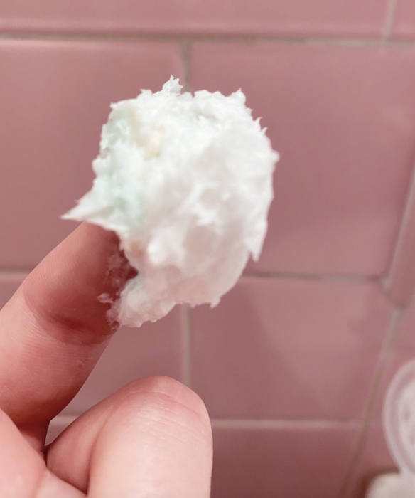 Some of the icing scooped out of the jar