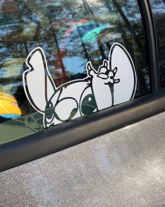 A white Stitch decal on a car window