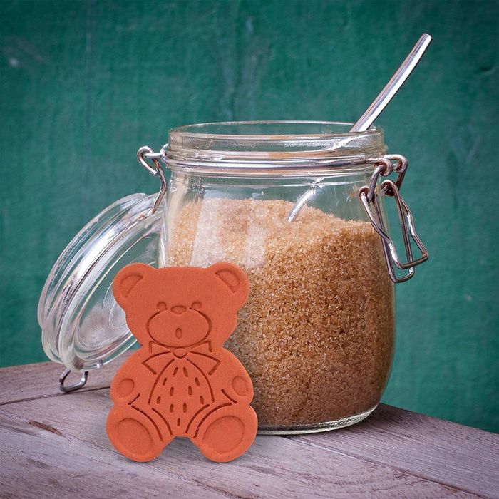 The bear placed next to a jar of brown sugar, ready to keep it fresh.