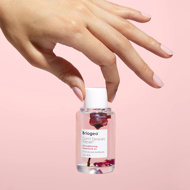 bottle of oil with tiny rose inside