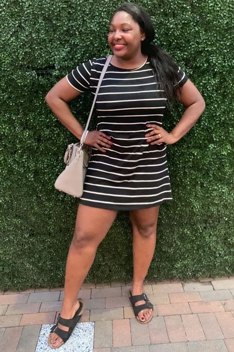Reviewer dressed in a black dress
