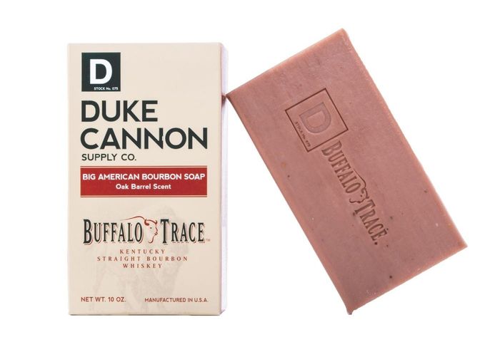 The soap, which comes in a light brown hue and is shaped as a rectangular bar.