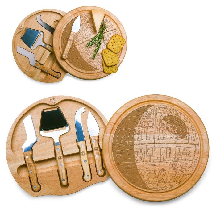 The cutting board, which features a round, wood-colored design with the iconic Death Star image engraved on the top, and includes a hidden compartment holding four cheese knives.