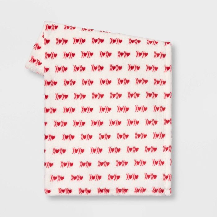 The blanket, which is white, features
