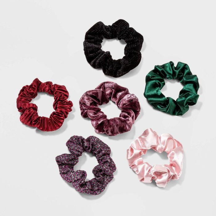 The set includes six scrunchies in an array of colors and fabrics, from silky to velvety textures.