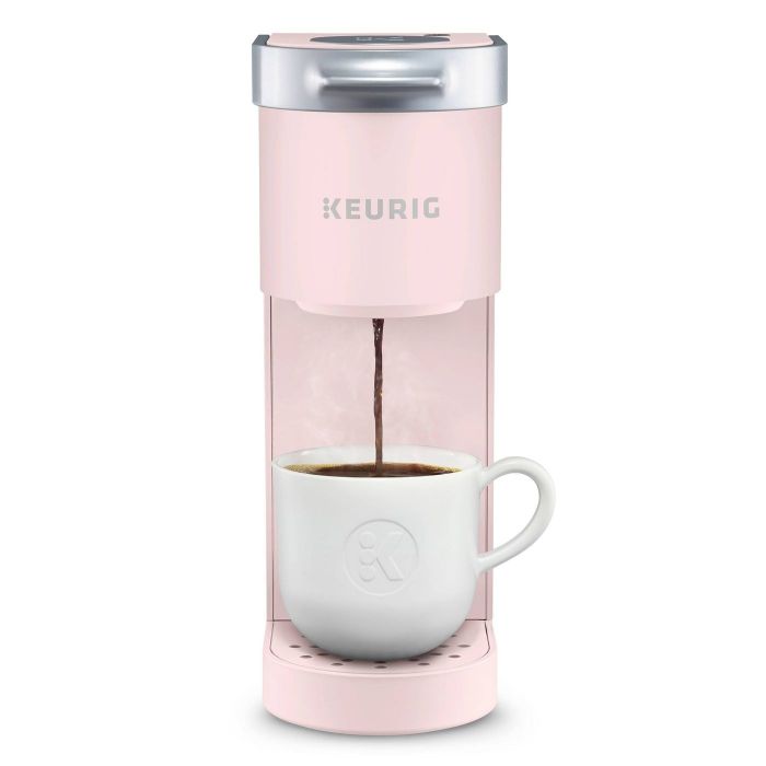 This light pink coffee maker is slim, designed for brewing a single cup of coffee at a time, making it ideal for coffee lovers.