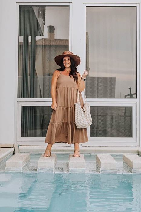 A reviewer in the taupe sleeveless dress