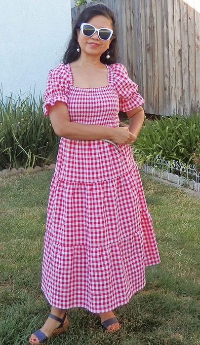 A reviewer in the red plaid dress