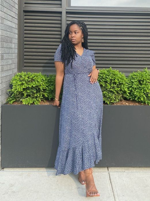 A reviewer in the micro floral dress