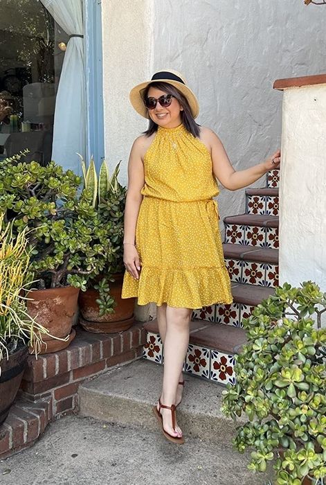 A reviewer in the yellow polka dot dress