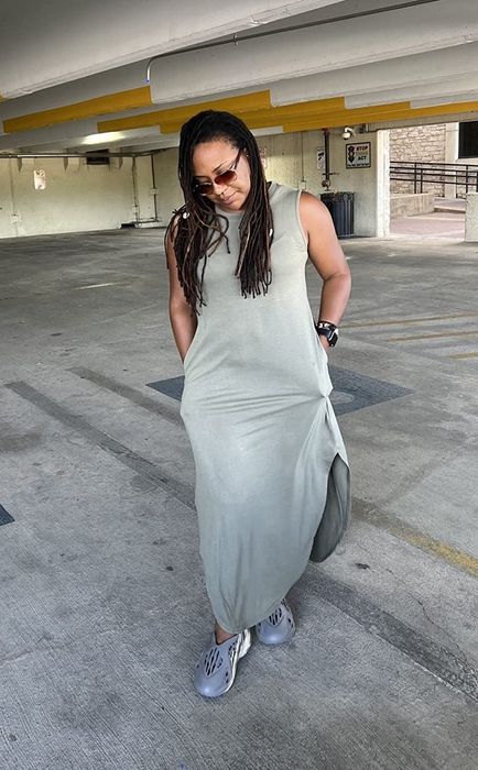 A reviewer in the grey maxi dress