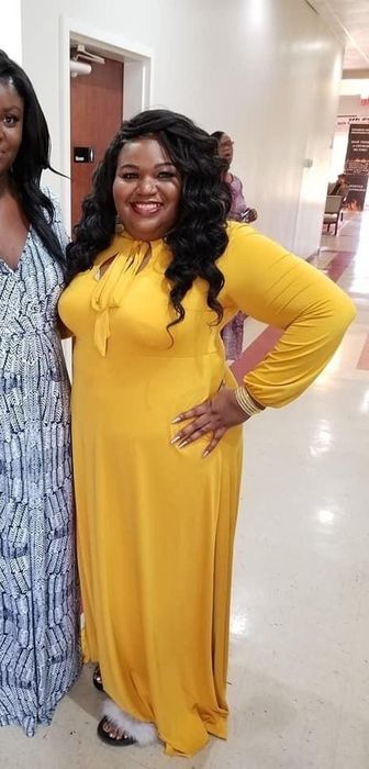 A reviewer in the bright yellow keyhole front dress