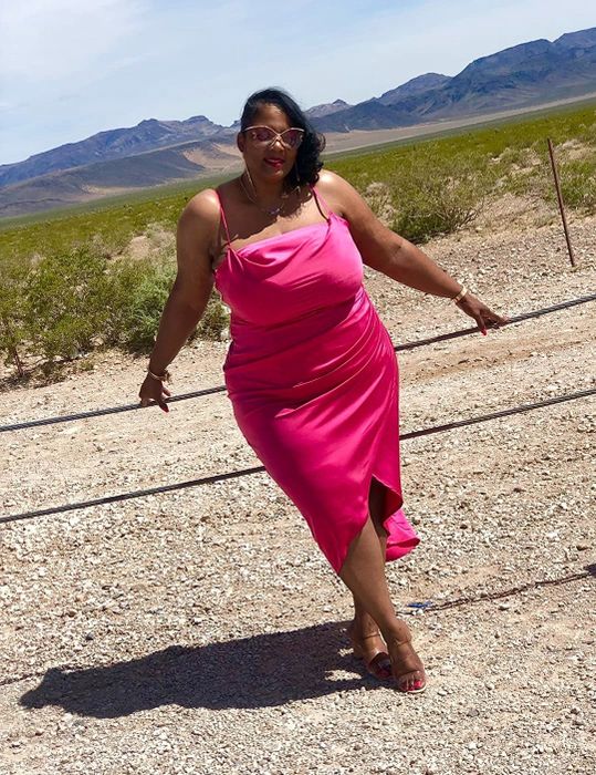 A reviewer in the fuchsia midi dress