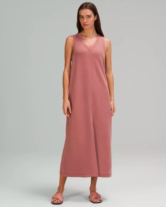 Model showcasing the V-neck tank dress in a flattering salmon pink color