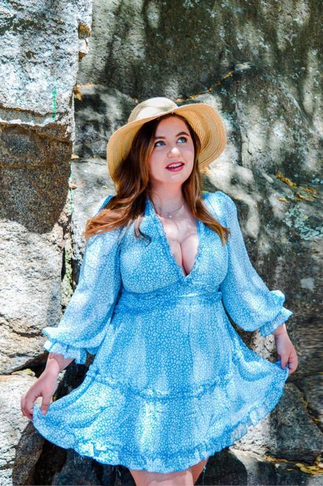 A reviewer wearing the blue long sleeve dress