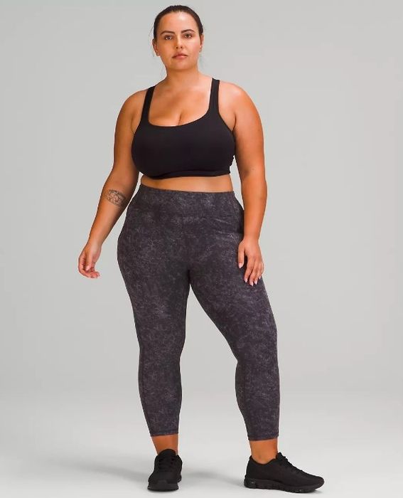 A model showcasing the purple patterned leggings