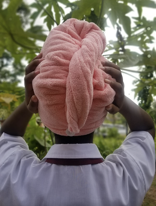 A reviewer’s image of someone wearing a pink towel and demonstrating the back view