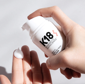 A bottle of K18 Repair Hair Mask on display