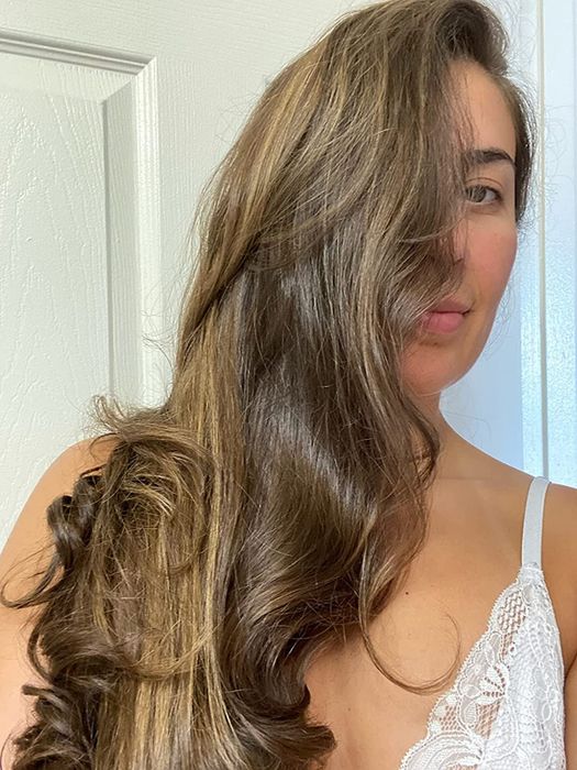 a reviewer's long, curly hair