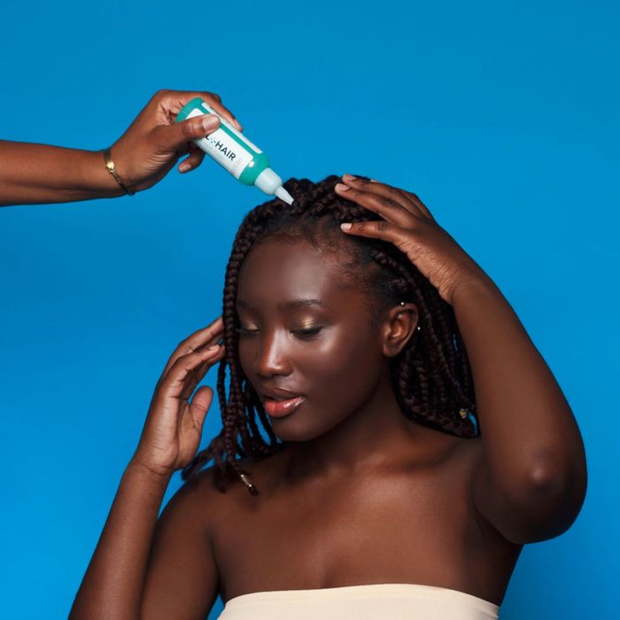 A model demonstrating the application of the treatment on their scalp.